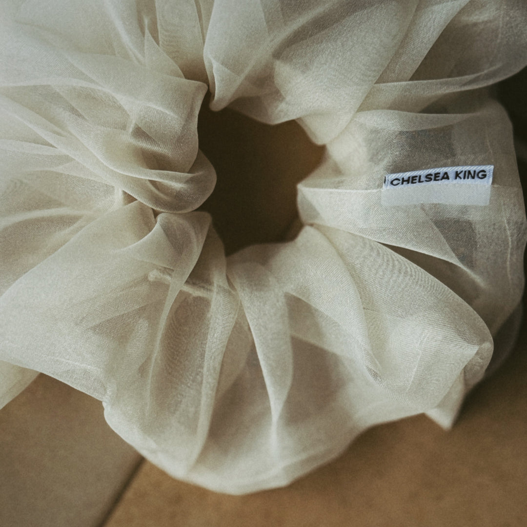 White sheer fabric with a label on a cardboard surface