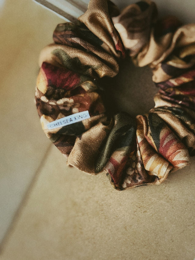 Floral patterned scrunchie on a beige surface